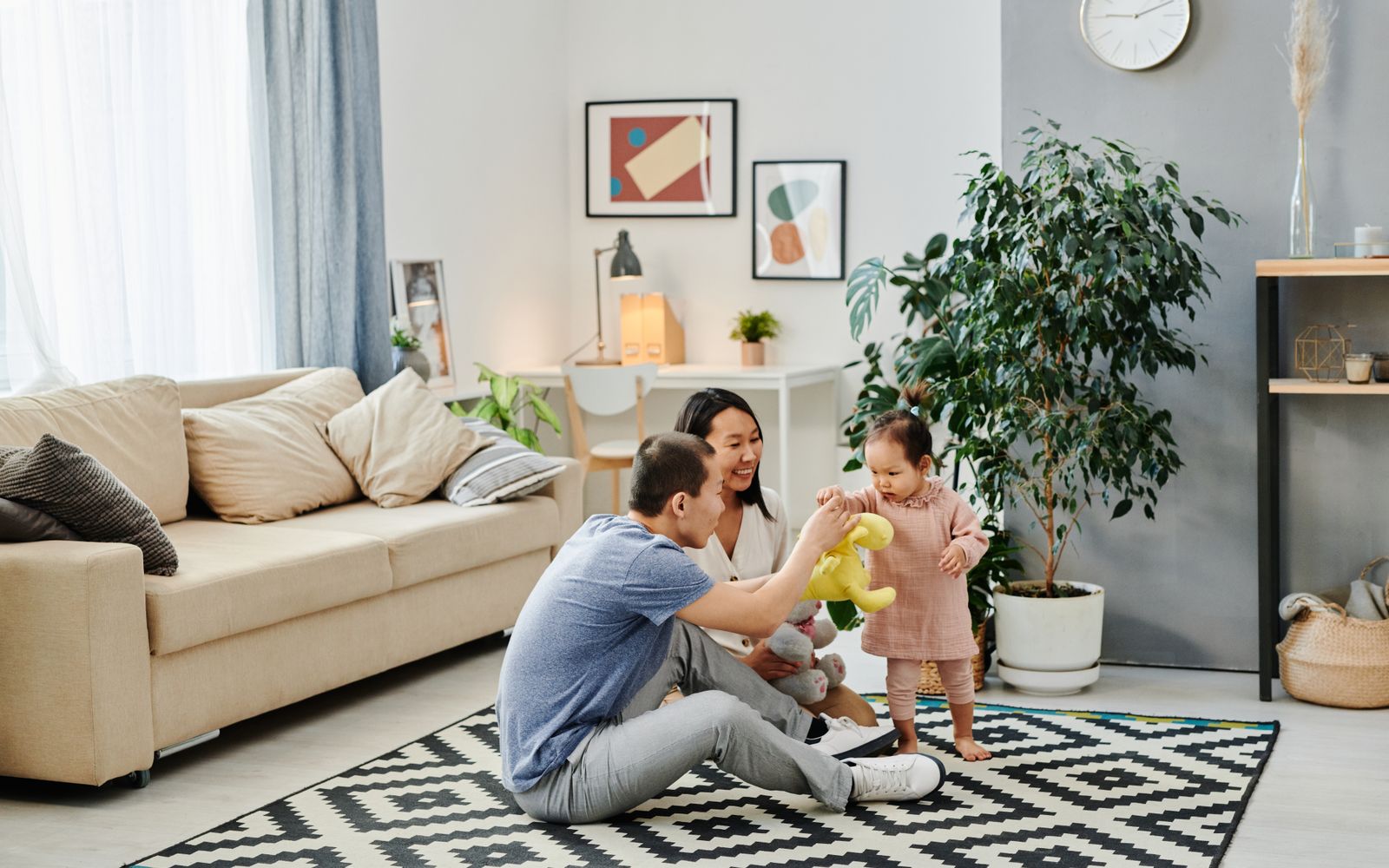 Toddler room with low shelves, cushions, and an art easel